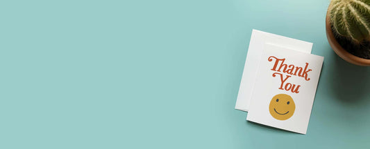image of a smiley face thank you card with a blue background and a decorative cactus next to it