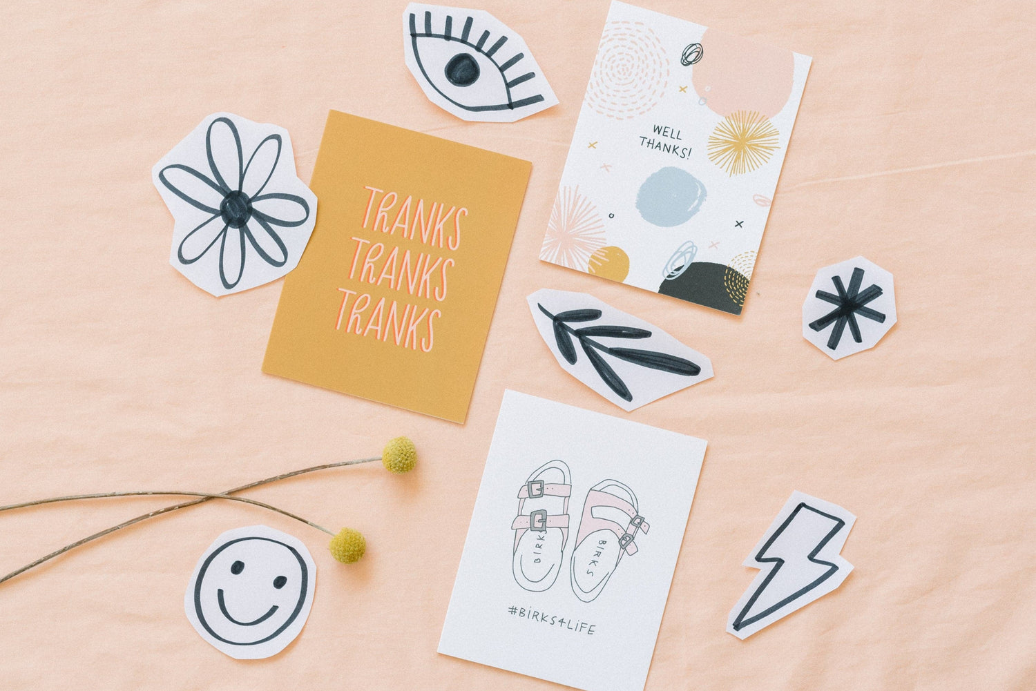 photograph of Hello Doodle cards on a pink background with illustrated doodles surrounding them